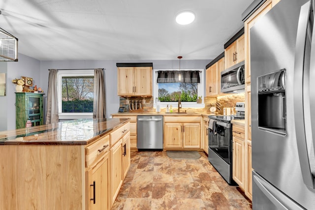 kitchen with light brown cabinetry, tasteful backsplash, and stainless steel appliances