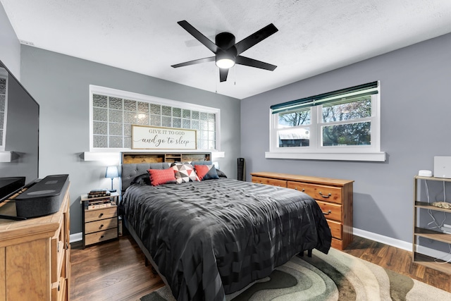 bedroom with dark wood finished floors, baseboards, and ceiling fan