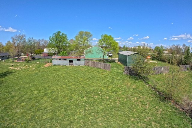 view of yard featuring fence and an outdoor structure