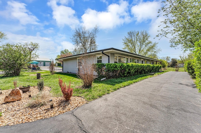 view of side of property with a yard