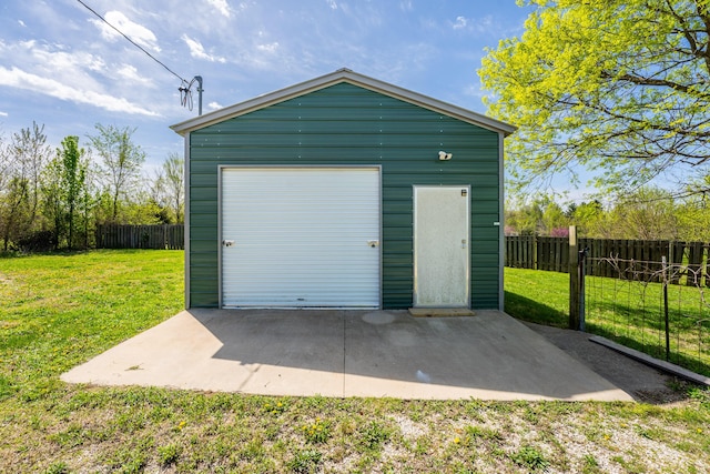 detached garage featuring fence