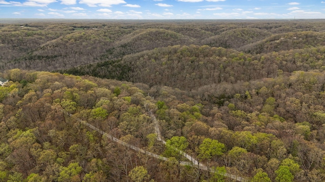 drone / aerial view featuring a wooded view