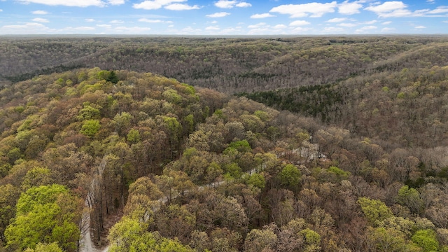 birds eye view of property featuring a view of trees