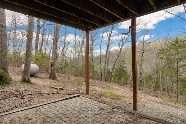 view of patio / terrace with a forest view