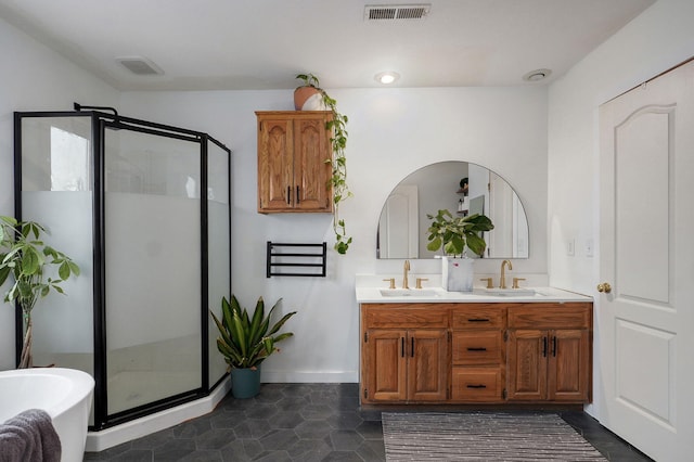 full bath featuring visible vents, a sink, and a shower stall