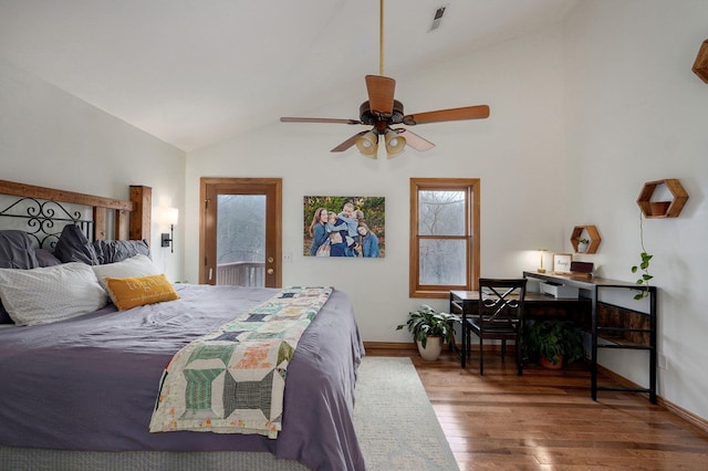 bedroom with wood finished floors, baseboards, lofted ceiling, access to exterior, and visible vents