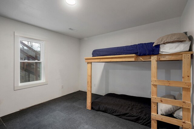 bedroom with visible vents and carpet