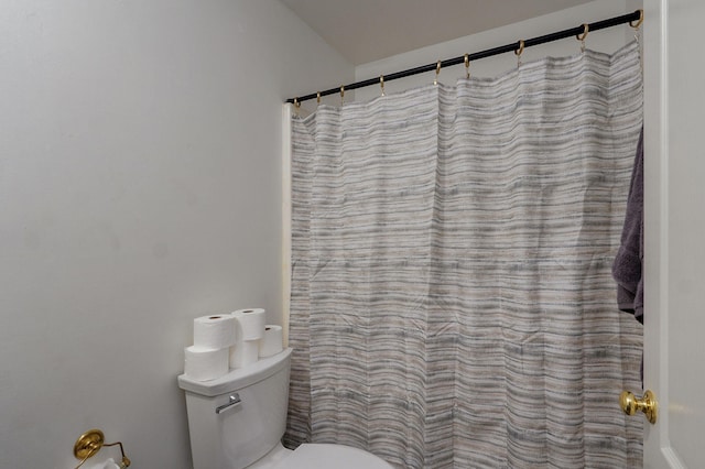 bathroom featuring toilet and a shower with curtain