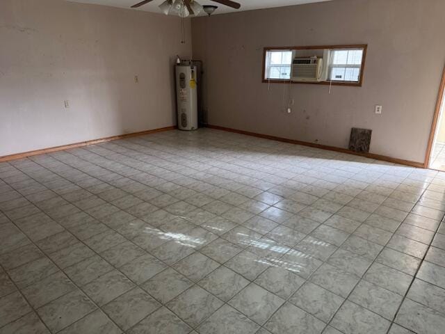 unfurnished room with ceiling fan, baseboards, electric water heater, and cooling unit