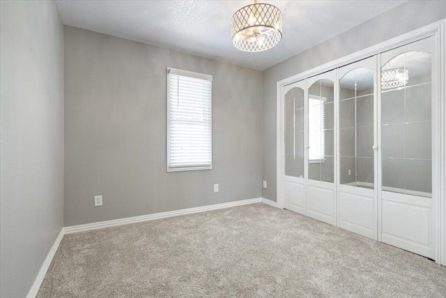 101 Poindexter Dr, Pineville, MO 64856 - spare room with carpet flooring, baseboards, and a notable chandelier