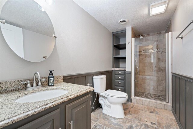 101 Poindexter Dr, Pineville, MO 64856 - full bathroom featuring visible vents, a wainscoted wall, and a stall shower