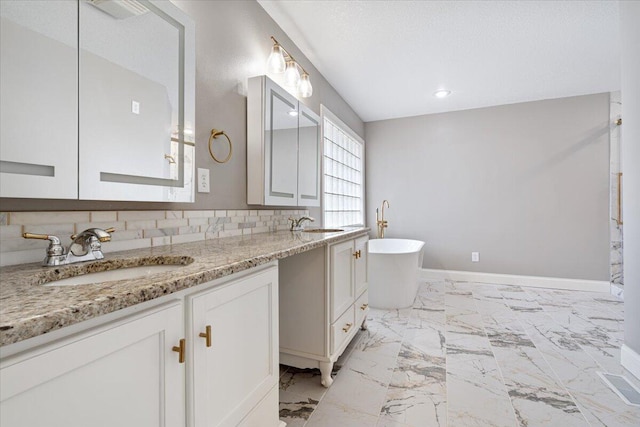 101 Poindexter Dr, Pineville, MO 64856 - bathroom featuring marble finish floor, a sink, double vanity, and a freestanding bath