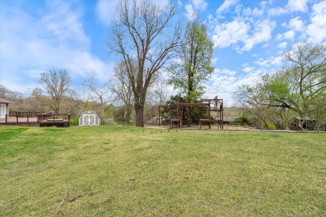 101 Poindexter Dr, Pineville, MO 64856 - view of yard with a storage shed, an outbuilding, a wooden deck, and a playground