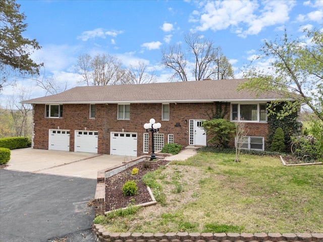 101 Poindexter Dr, Pineville, MO 64856 - view of front of house with brick siding, a front lawn, driveway, and a garage