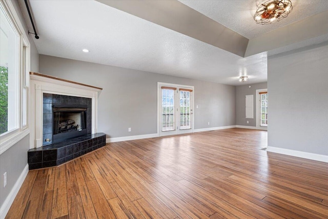 101 Poindexter Dr, Pineville, MO 64856 - unfurnished living room featuring hardwood / wood-style floors, baseboards, and a healthy amount of sunlight