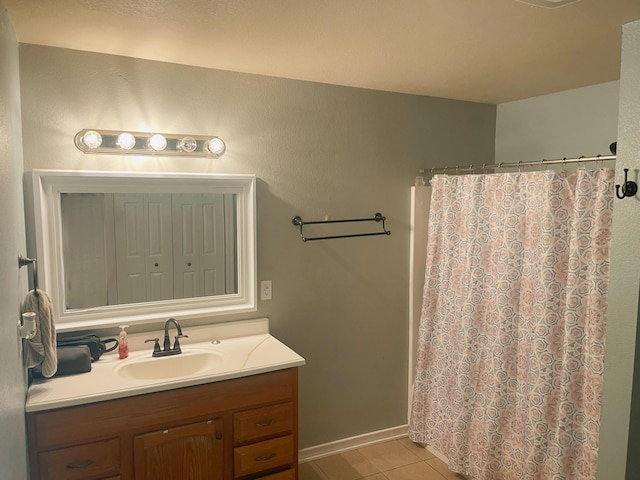 full bath featuring a shower with shower curtain, tile patterned flooring, and vanity