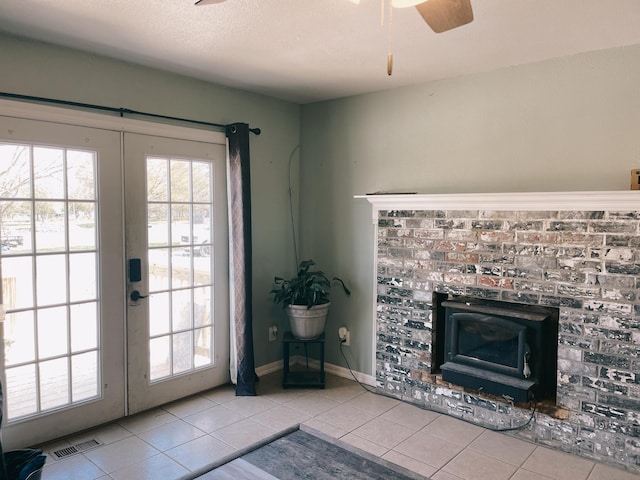 doorway to outside with tile patterned flooring, ceiling fan, french doors, and visible vents