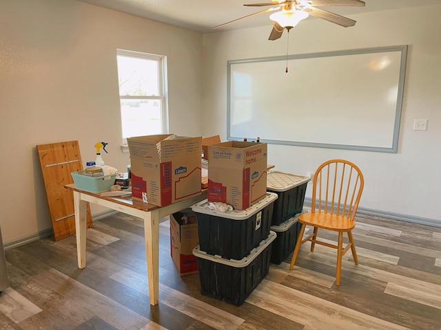 dining room with baseboards, a ceiling fan, and wood finished floors