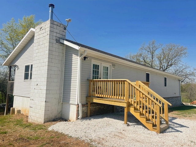 rear view of property with a wooden deck