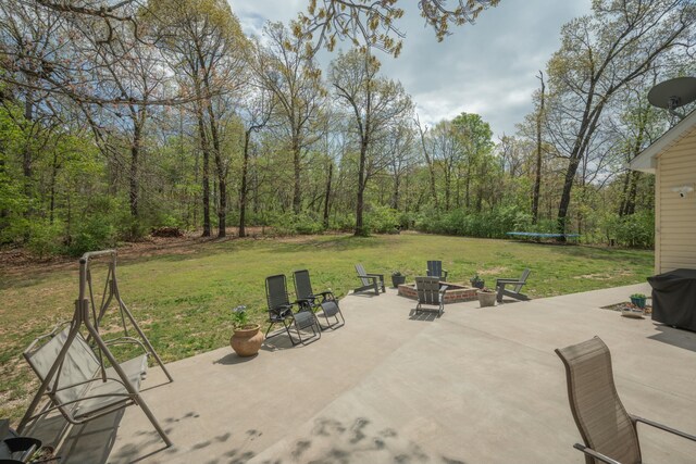 view of patio featuring a fire pit and a trampoline