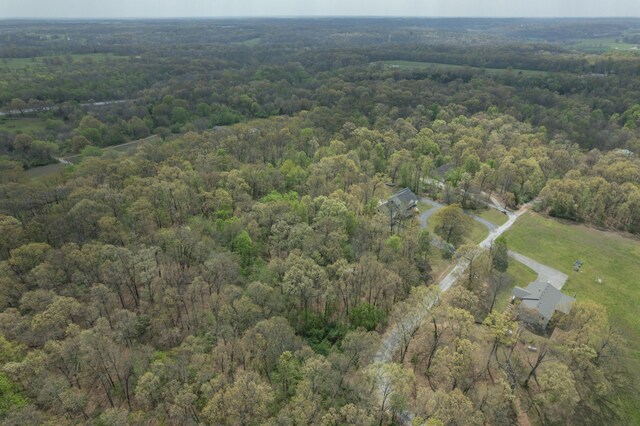 birds eye view of property featuring a wooded view