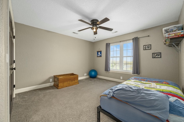 bedroom featuring baseboards, visible vents, carpet, and a textured ceiling