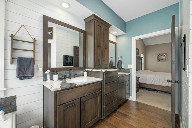 full bath with wood finished floors, ensuite bath, and vanity