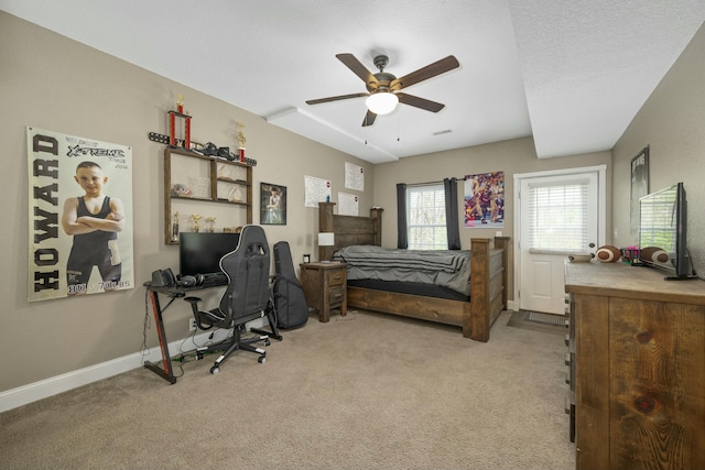 bedroom featuring light colored carpet, baseboards, and a ceiling fan