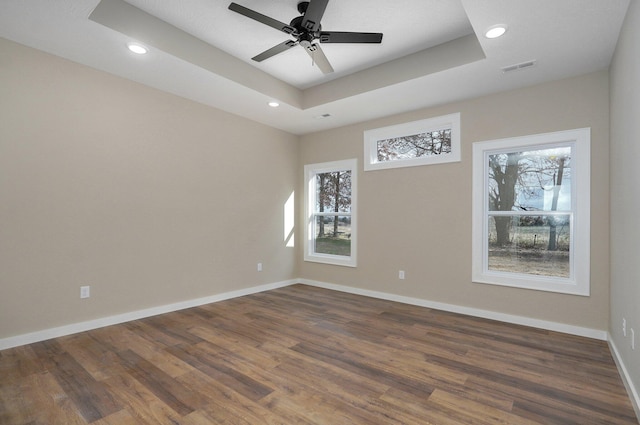 5464 Anita Ave, Pleasant Hope, MO 65725 - spare room featuring dark wood-type flooring, recessed lighting, ceiling fan, baseboards, and a raised ceiling