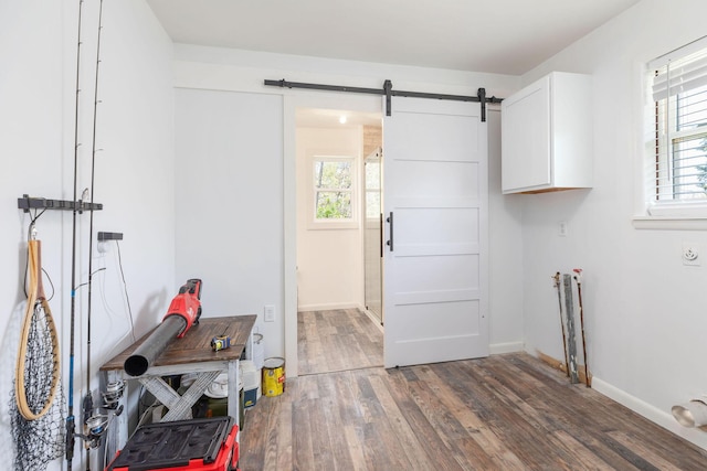 1 Edgemont Dr, Kimberling City, MO 65686 - laundry room featuring cabinet space, wood finished floors, baseboards, and a barn door