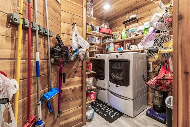 7745 Murr Rd, Graff, MO 65660 - washroom with washer and dryer, wood walls, wood finished floors, and laundry area