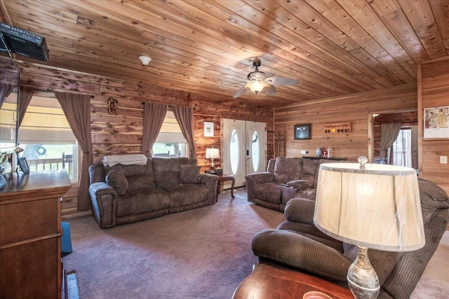 7745 Murr Rd, Graff, MO 65660 - carpeted living room featuring wood ceiling, wooden walls, and ceiling fan