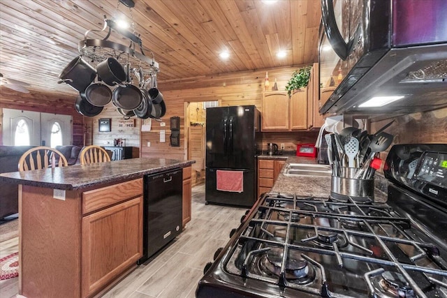 7745 Murr Rd, Graff, MO 65660 - kitchen with light wood finished floors, a center island, dark countertops, wood ceiling, and black appliances