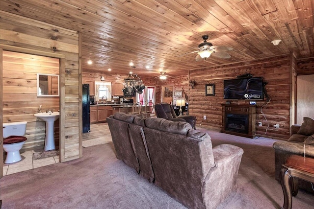 7745 Murr Rd, Graff, MO 65660 - carpeted living room with a ceiling fan, a sink, wood ceiling, a fireplace, and log walls