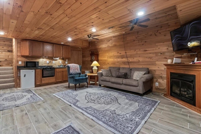 7745 Murr Rd, Graff, MO 65660 - living area with recessed lighting, light wood finished floors, wooden walls, a ceiling fan, and wood ceiling