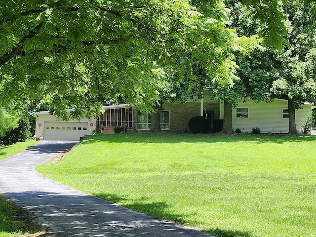702 W Hubble Dr, Marshfield, MO 65706 - obstructed view of property with driveway, a front lawn, and a garage