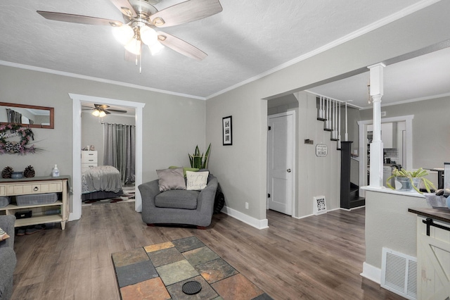 953 S Weaver Ave, Springfield, MO 65806 - living area featuring a ceiling fan, wood finished floors, stairway, baseboards, and ornamental molding