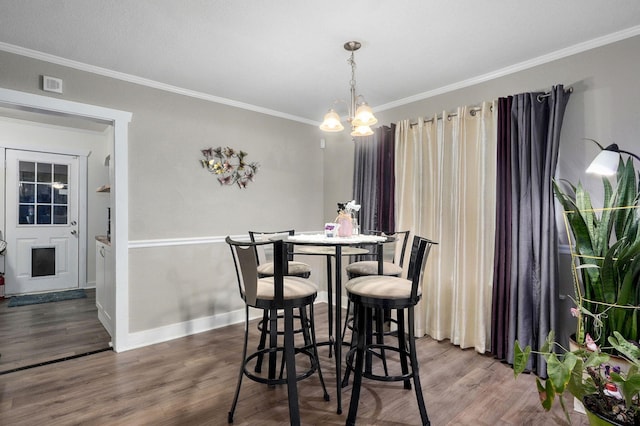 953 S Weaver Ave, Springfield, MO 65806 - dining space featuring crown molding, a chandelier, dark wood-style floors, and baseboards