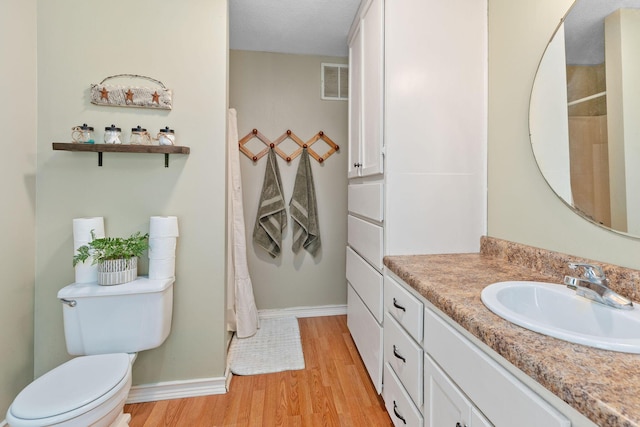344 Zinnia Ln, Kirbyville, MO 65679 - full bathroom with wood finished floors, toilet, baseboards, and vanity