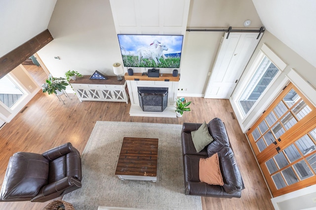344 Zinnia Ln, Kirbyville, MO 65679 - living area with wood finished floors, a barn door, baseboards, and a fireplace with raised hearth