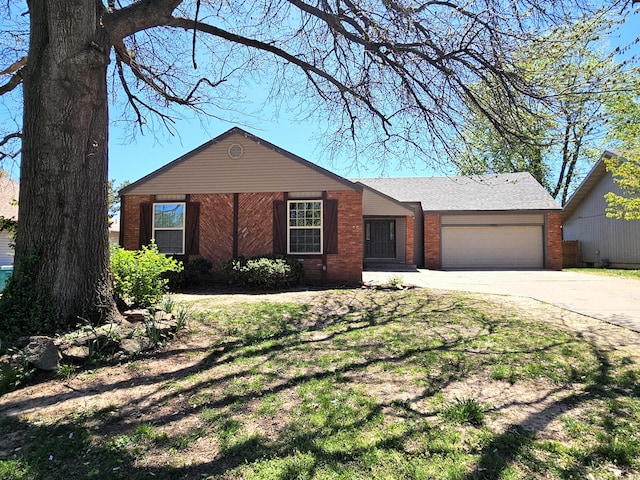 ranch-style house with brick siding, an attached garage, and driveway