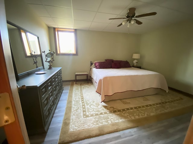 6475 S Farm Rd Unit 193, Rogersville, MO 65742 - bedroom with light wood-type flooring, baseboards, ceiling fan, and a paneled ceiling