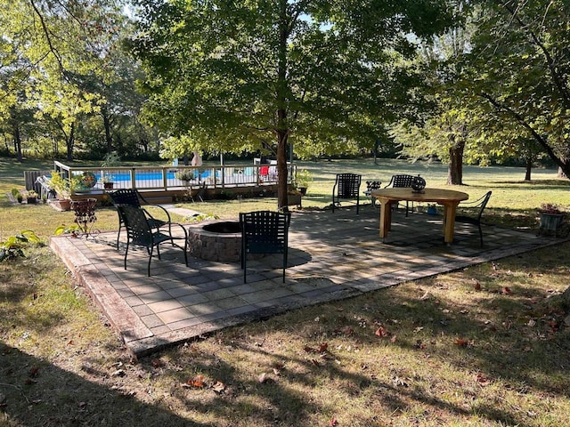 6475 S Farm Rd Unit 193, Rogersville, MO 65742 - view of property's community with a swimming pool, a fire pit, a patio, a yard, and view of scattered trees