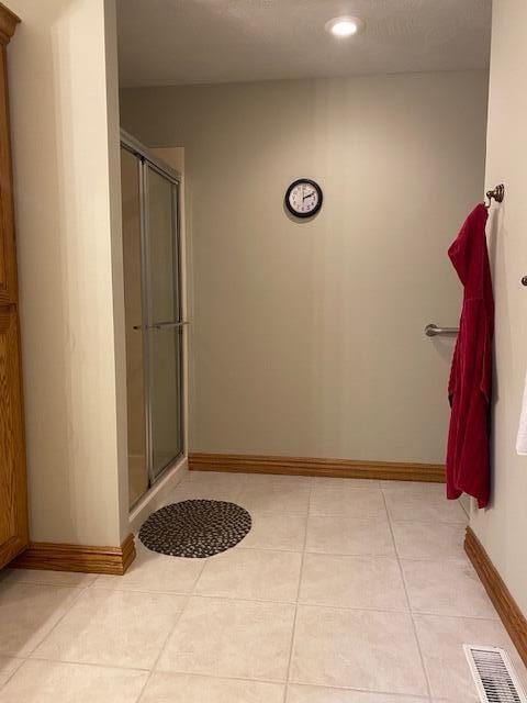 4822 S Montrose Pl, Springfield, MO 65810 - bathroom with a shower with door, tile patterned flooring, and visible vents