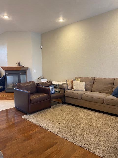 4822 S Montrose Pl, Springfield, MO 65810 - living area with a glass covered fireplace, wood finished floors, and recessed lighting
