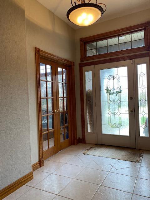 4822 S Montrose Pl, Springfield, MO 65810 - doorway with a textured wall, french doors, baseboards, and light tile patterned flooring