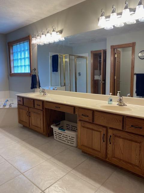 4822 S Montrose Pl, Springfield, MO 65810 - full bath with tile patterned floors, a garden tub, vanity, and a shower stall
