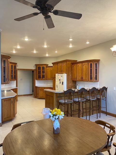 4822 S Montrose Pl, Springfield, MO 65810 - dining area featuring ceiling fan with notable chandelier, baseboards, and recessed lighting