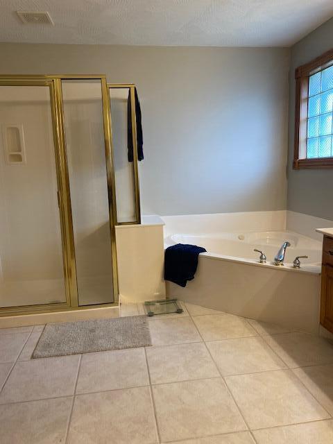 4822 S Montrose Pl, Springfield, MO 65810 - full bath with tile patterned floors, a garden tub, visible vents, and a shower stall