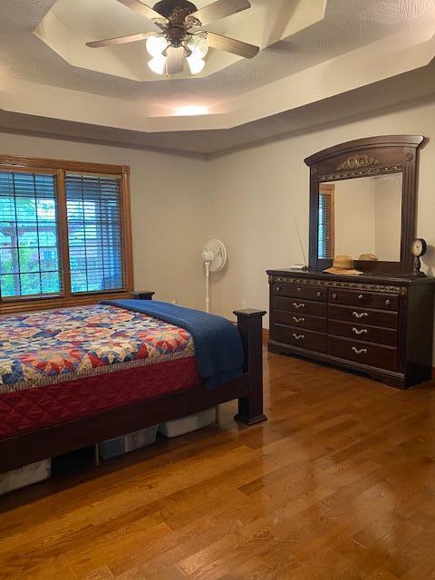 4822 S Montrose Pl, Springfield, MO 65810 - bedroom with a ceiling fan, wood finished floors, and a raised ceiling
